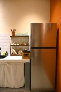 a stainless steel refrigerator in a kitchen at Mer Home in Tây Ninh