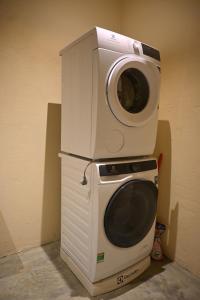 a washing machine sitting on top of a microwave at Mer Home in Tây Ninh