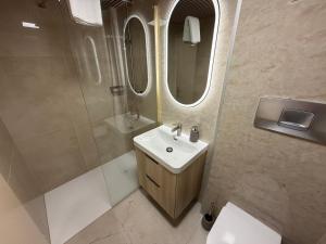 a bathroom with a sink and a mirror at City Apartments in Brunnen