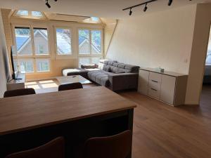 a living room with a couch and a table at City Apartments in Brunnen +12 photos