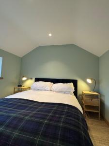 a bedroom with a large bed with two pillows at The Sheep Barn in Weathercote