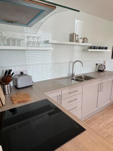 a kitchen with a sink and a counter top at The Sheep Barn in Weathercote +7 photos