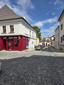 a cobblestone street in a small town with buildings at Apartmán Kräm in Klatovy