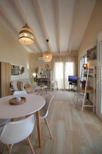 a living room with a table and chairs at Amanda's House in Poros +23 photos