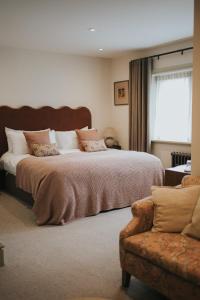 a bedroom with a large bed and a couch at Longridge House in Longridge +117 photos
