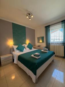 a bedroom with a large bed with two towels on it at Apartments Ostojic in Krk