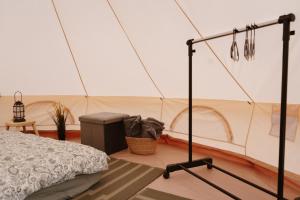 a room with a bed in a tent at Mardi talu Glamping in Paekna