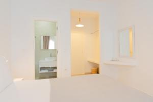 a white bathroom with a sink and a mirror at Harmony Hotel in Sarandë +91 photos