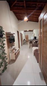 a large living room with a couch and a television at Chácara Marias Da Serra in Araruna