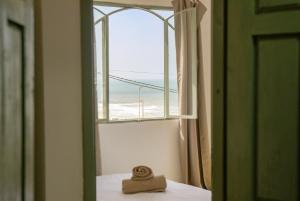 a hat sitting on a table in front of a window at Sand House in Imsouane