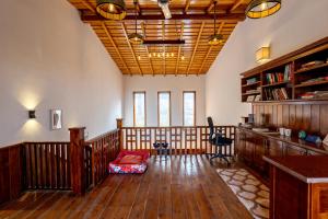 a living room with wooden floors and a ceiling at SaffronStays Brookside Estate in Rānīkhet