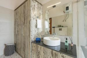a bathroom with a sink and a mirror at SaffronStays Brookside Estate in Rānīkhet +50 photos