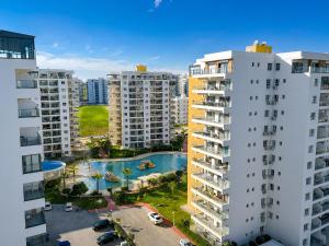 an aerial view of two apartment buildings and a pool at Caesar Resort & Spa Collection Studios Pools & Long Beach in Iskele