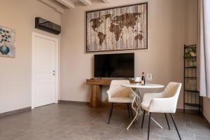 a living room with a table and a tv at Corte Lavarini The Magic At Sight in Fumane