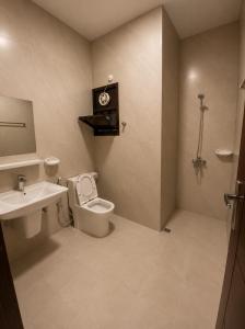 a bathroom with a toilet and a sink at RED Gardenia in Salalah +40 photos