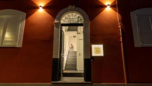 a mirror on the wall of a building with a staircase at Aetna LuxurySuites in Catania