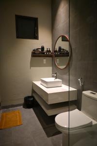 a bathroom with a sink and a toilet and a mirror at Mer Home in Tây Ninh +43 photos