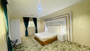 a bedroom with a large bed in a room at Al Raiyan Serviced Apartments in Taif