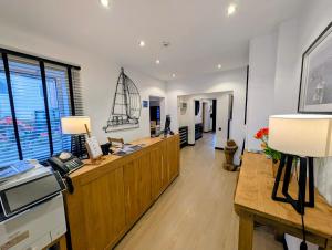 a large room with a desk with a sail on the wall at Hotel B&R Piano 2 - Louvain-la-Neuve - Mont Saint Guibert in Louvain-la-Neuve