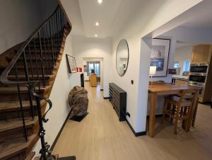 a living room with a staircase and a dining room at Hotel B&R Piano 2 - Louvain-la-Neuve - Mont Saint Guibert in Louvain-la-Neuve