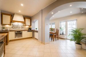 an open kitchen and dining room with a table at Villa Aqua Wągrowiec Pool House in Wągrowiec +11 photos