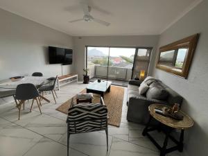 a living room with a couch and a table at T&A Escape in Grassy Park