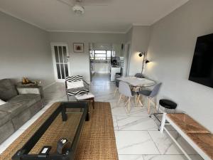a living room with a couch and a table at T&A Escape in Grassy Park