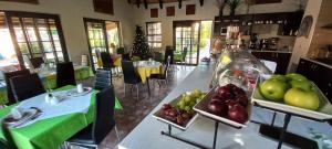 a kitchen with a table with fruits and vegetables on it at Capbon Guesthouse in Windhoek