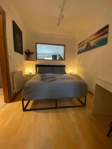 a bedroom with a bed and a mirror on the wall at Apt 2 Cathedral & River view in Norwich