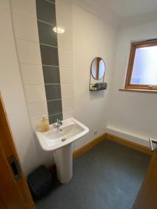 a bathroom with a sink and a mirror and a tub at Apt 2 Cathedral & River view in Norwich +6 photos