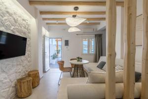 a living room with a couch and a table at Michalakis Seaside Suites in Pollonia