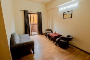 a living room with chairs and a table and a window at Hotel Maurya Regency in Morjim