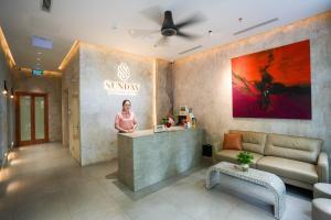 a woman standing at a counter in a salon at Sunday Boutique Hotel in Phú Quốc