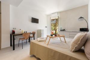a living room with a bed and a table at Residence Punta Cassano - In piscina sulla spiaggia di sabbia in San Foca