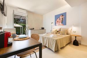 a living room with a bed and a table at Residence Punta Cassano - In piscina sulla spiaggia di sabbia in San Foca