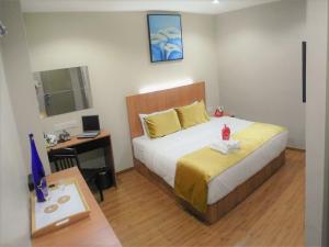 Postel nebo postele na pokoji v ubytování Royale Hotel Batu Gajah