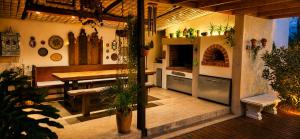 a kitchen with a wooden table and a kitchen with a counter at Alimandi Villa in Klapmuts