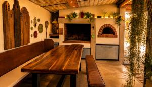 a kitchen with a wooden table and benches in a room at Alimandi Villa in Klapmuts +24 photos
