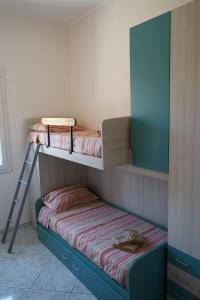 two bunk beds in a room with a ladder at 900 Dal Blu in Licata