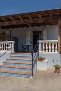 a house with stairs leading to a patio at 900 Dal Blu in Licata +8 photos