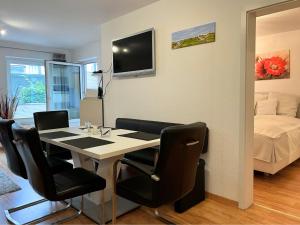 a room with a table and chairs and a bed at Komfortable Ferienwohnung mit Terrasse auf Fehmarn in Fehmarn