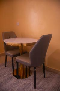 a table and two chairs sitting next to a table at Cisa Homes in Gatunga