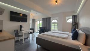 a bedroom with a bed and a desk with a computer at Alter Kornspeicher in Havelberg