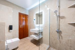 a bathroom with a shower and a toilet and a sink at Hotel Montenegrino in Tivat +47 photos