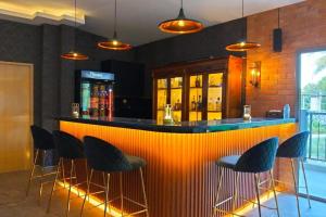 a bar in a restaurant with chairs around it at Varaya Resort in Ban Kraek