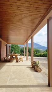 an outdoor patio with a table and picnic tables at Casa Lis in Atei