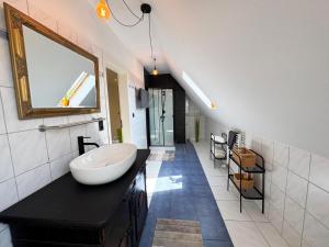 a bathroom with a sink and a mirror on a counter at Ferienwohnung am Haff in Ueckermünde +15 photos