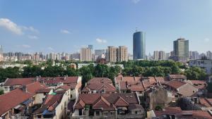 a group of houses in a city with tall buildings at 無桐Mini酒店WowTown in Shanghai