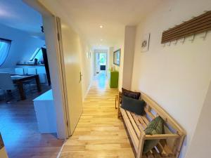 a hallway of a house with a bench and a table at Ferienwohnung am Haff in Ueckermünde