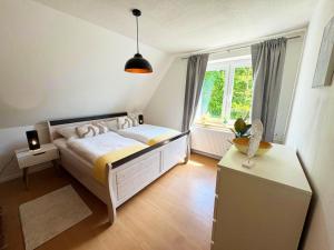 a bedroom with a large bed and a window at Ferienwohnung am Haff in Ueckermünde
